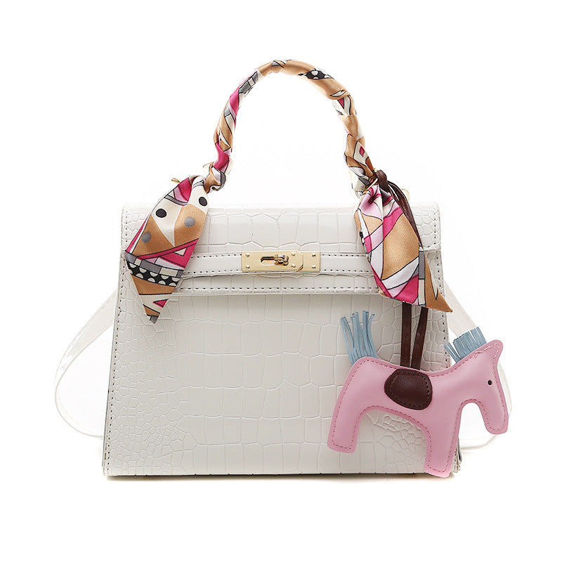 Stone pattern PU leather shoulder bag with a pink horse keychain and colorful scarf accents.