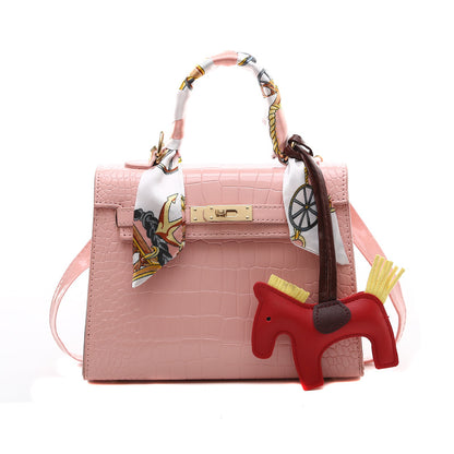 Stylish stone pattern PU leather shoulder bag with a decorative charm and scarf, perfect for fashion-forward women.