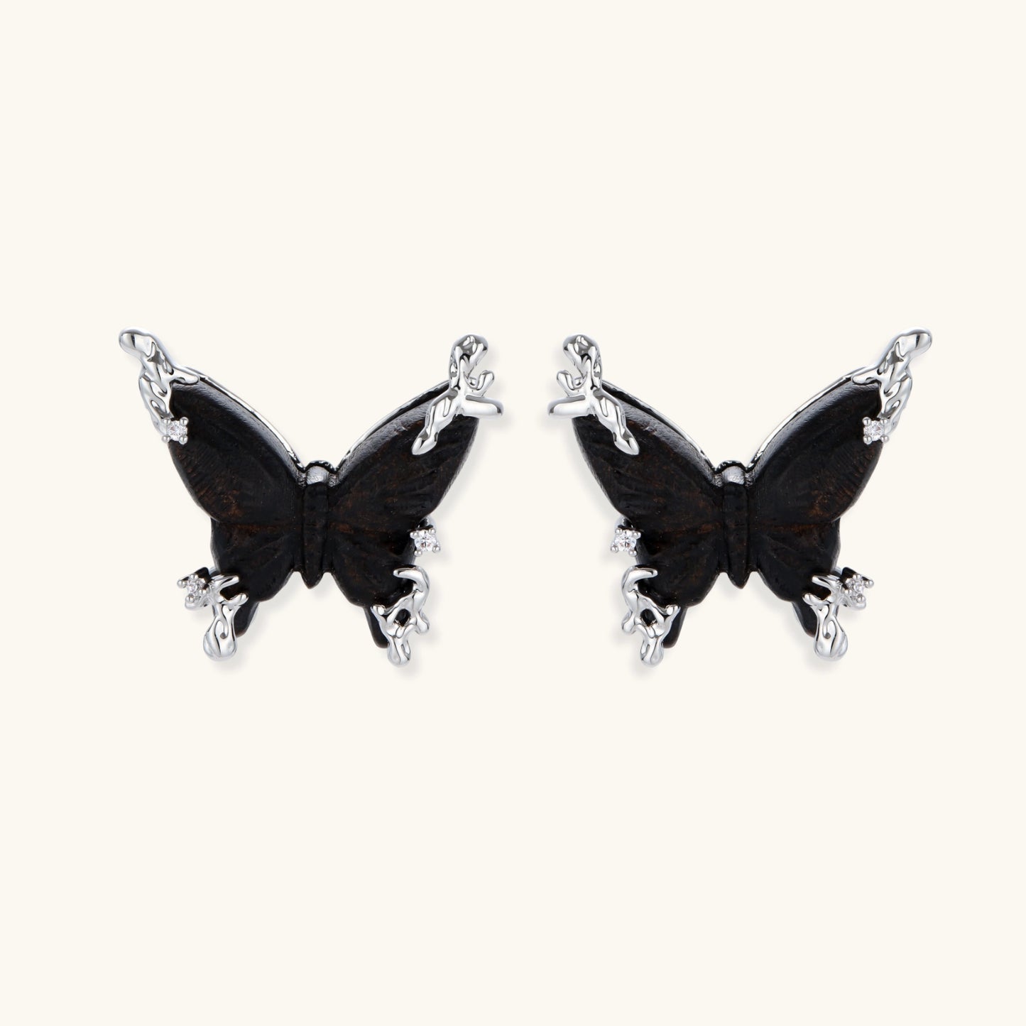 Wooden butterfly earrings with silver chain details in light and dark wood variants on white background