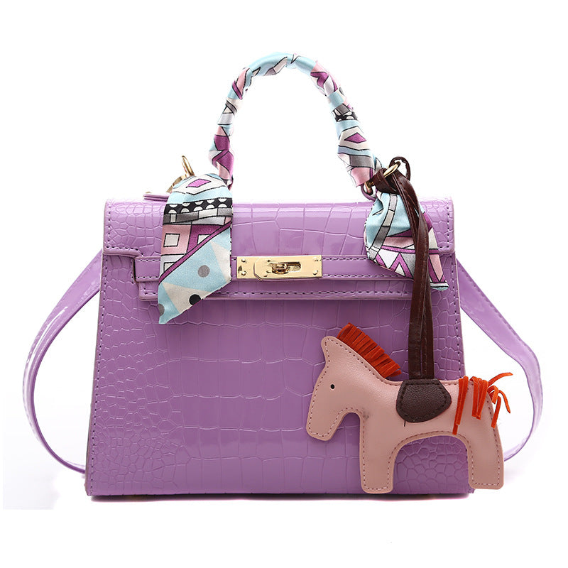 Stone pattern PU leather shoulder bag with purple finish and playful horse charm.